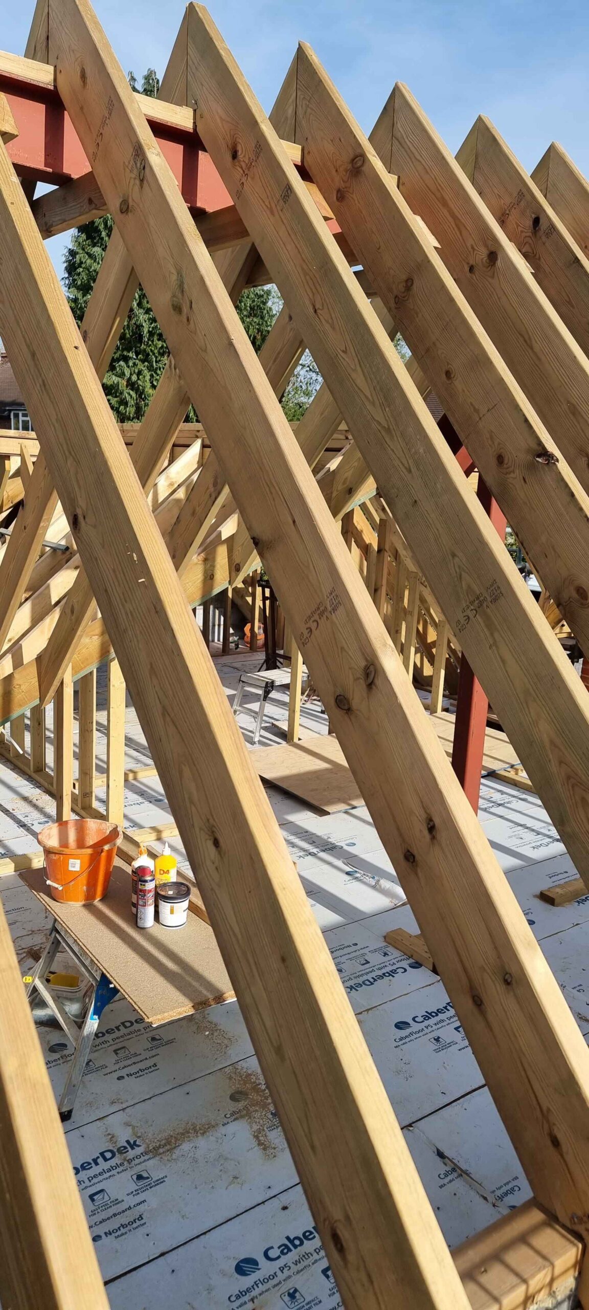 Roofing project in the Cotswolds. Wooden trusses in the sunshine.